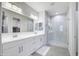 Luxurious bathroom featuring a double sink vanity and a modern glass-enclosed shower at 40440 W Haley Dr, Maricopa, AZ 85138