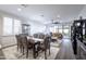 Open-concept dining area with a wooden table, rug, and modern decor at 40440 W Haley Dr, Maricopa, AZ 85138