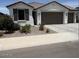 Charming single-story home with a two car garage, desert landscaping, and a neutral color palette at 40440 W Haley Dr, Maricopa, AZ 85138