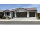 Charming single-story home with a two car garage, desert landscaping, and a neutral color palette at 40440 W Haley Dr, Maricopa, AZ 85138