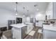 Modern kitchen featuring stainless steel appliances, a kitchen island, and pendant lighting at 40440 W Haley Dr, Maricopa, AZ 85138