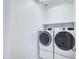 Functional laundry room with white appliances and ample space at 40440 W Haley Dr, Maricopa, AZ 85138