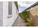 Side yard featuring a gravel path, offering a functional outdoor space at 40440 W Haley Dr, Maricopa, AZ 85138