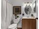 Cozy bathroom with decorative framed art and a vanity with a round mirror at 461 W Holmes Ave # 277, Mesa, AZ 85210