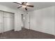 Bedroom showing a ceiling fan, neutral paint, closet, and connecting rooms at 461 W Holmes Ave # 277, Mesa, AZ 85210