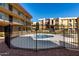 Community pool area fenced in with landscaping around the exterior at 461 W Holmes Ave # 277, Mesa, AZ 85210