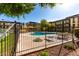 View of the community pool area, featuring lounge seating and mature trees, surrounded by the apartment complex at 461 W Holmes Ave # 277, Mesa, AZ 85210