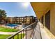 Balcony view showcases well-maintained landscaping and a community pool within an apartment complex setting at 461 W Holmes Ave # 277, Mesa, AZ 85210