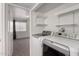 Well-lit laundry area complete with modern machines and functional shelving at 461 W Holmes Ave # 277, Mesa, AZ 85210