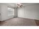 Living room featuring a ceiling fan, carpet flooring, and a large window for natural light at 461 W Holmes Ave # 277, Mesa, AZ 85210