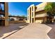 Spacious parking area with covered spaces and easy access to the residential building's entrance and stairs at 461 W Holmes Ave # 277, Mesa, AZ 85210