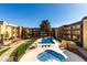 A refreshing swimming pool and jacuzzi area surrounded by well-maintained landscaping and apartment buildings at 461 W Holmes Ave # 277, Mesa, AZ 85210