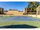 Well-lit tennis court for sports enthusiasts in a community setting with residential buildings nearby at 461 W Holmes Ave # 277, Mesa, AZ 85210