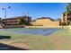 Tennis court features a net and lighting for evening play, surrounded by residential buildings at 461 W Holmes Ave # 277, Mesa, AZ 85210