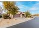 Single-story home with desert landscaping, a charming bench, and a spacious two-car garage at 4760 E Amber Sun Dr, Cave Creek, AZ 85331