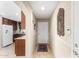 Inviting hallway showcasing tile floors, leading to the kitchen with granite counters and white appliances at 4760 E Amber Sun Dr, Cave Creek, AZ 85331