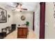 Well-lit home office with tiled floors, ceiling fan, a desk, and a window for natural light at 4760 E Amber Sun Dr, Cave Creek, AZ 85331