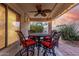 Inviting covered patio with elegant seating, ceiling fan, and view to the lush landscaping and pool at 4760 E Amber Sun Dr, Cave Creek, AZ 85331