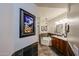 Bathroom with a soaking tub, dual sinks, tiled floors and a desert themed art piece at 5350 E Deer Valley Dr # 2236, Phoenix, AZ 85054