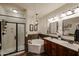 Bathroom featuring a glass shower, a soaking tub, double sinks and mirrors at 5350 E Deer Valley Dr # 2236, Phoenix, AZ 85054