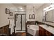 Stylish bathroom featuring a soaking tub, glass-enclosed shower, and unique tile accents at 5350 E Deer Valley Dr # 2236, Phoenix, AZ 85054