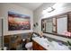 Stylish bathroom with tiled walls, white countertops, and a framed mirror above the sink at 5350 E Deer Valley Dr # 2236, Phoenix, AZ 85054