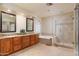 Primary bathroom features a double vanity, soaking tub, and glass-enclosed shower with tile surround at 5381 W Del Rio St, Chandler, AZ 85226