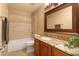 Well-lit bathroom with updated granite countertop and decorative backsplash at 5381 W Del Rio St, Chandler, AZ 85226