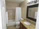 Bathroom with a shower-tub combo, tiled walls, and vanity with granite countertop at 5381 W Del Rio St, Chandler, AZ 85226