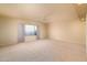 Spacious bedroom with neutral carpet, ceiling fan, and ample natural light from the large window at 5381 W Del Rio St, Chandler, AZ 85226