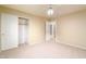 Carpeted bedroom with closet and open door to the hall at 5381 W Del Rio St, Chandler, AZ 85226