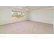 Bright bedroom with large window and neutral carpet offers a calming space with ample natural light at 5381 W Del Rio St, Chandler, AZ 85226