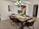 Staged dining room featuring a wooden table, black chairs, and a modern chandelier at 5381 W Del Rio St, Chandler, AZ 85226