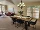 Cozy dining room featuring a wooden table, black chairs, and a modern chandelier at 5381 W Del Rio St, Chandler, AZ 85226