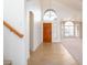 Inviting foyer with high ceilings, tile flooring, and a wood front door with arched window at 5381 W Del Rio St, Chandler, AZ 85226