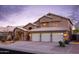 Charming two-story home featuring a three-car garage, desert landscaping, and well-lit exterior at 5381 W Del Rio St, Chandler, AZ 85226