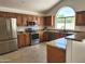 Modern kitchen with stainless steel appliances, granite countertops, and ample cabinet space at 5381 W Del Rio St, Chandler, AZ 85226