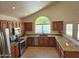 Well-appointed kitchen with granite countertops, stainless steel appliances and natural lighting at 5381 W Del Rio St, Chandler, AZ 85226