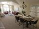 Open-concept living and dining areas with a dining table, six chairs, and modern decor at 5381 W Del Rio St, Chandler, AZ 85226