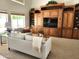 Spacious living room features a custom built-in entertainment center and comfortable seating at 5381 W Del Rio St, Chandler, AZ 85226