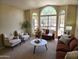 Inviting living room with large windows, stylish furniture, and neutral color palette at 5381 W Del Rio St, Chandler, AZ 85226