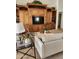 Well-lit living room with built-in shelving, a comfortable sofa, and accent plants at 5381 W Del Rio St, Chandler, AZ 85226