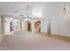 Open-concept living room with mirrored wall, tile flooring, and views of the dining area and kitchen at 5381 W Del Rio St, Chandler, AZ 85226