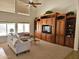Spacious living room features a built-in entertainment center and large windows at 5381 W Del Rio St, Chandler, AZ 85226