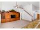 Open living room featuring built-in cabinets, carpet flooring, a ceiling fan, and staircase to upper level at 5381 W Del Rio St, Chandler, AZ 85226