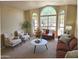 Bright living room features large windows, comfortable seating and cozy decor at 5381 W Del Rio St, Chandler, AZ 85226