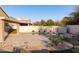 A backyard pool is surrounded by a well manicured patio, lush landscape, and privacy wall at 5381 W Del Rio St, Chandler, AZ 85226