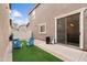 Cozy backyard featuring green artificial turf, chairs, a sliding glass door, and a block fence at 5824 E Hoover Ave, Mesa, AZ 85206