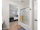 Bathroom with a glass-enclosed shower and a partial view of the bedroom at 5824 E Hoover Ave, Mesa, AZ 85206