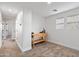 Hallway leads into a well-lit bedroom with two windows, carpet flooring and a workspace at 5824 E Hoover Ave, Mesa, AZ 85206